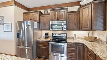 Dishwasher, coffee/tea maker, cookware/dishes/utensils, dining tables