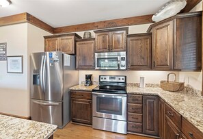 Dishwasher, coffee/tea maker, cookware/dishes/utensils, dining tables