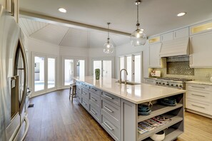 A spacious kitchen with a large island, stainless steel appliances, and pendant lighting. - 15 Duck Hawk-4th Row Ocean!  A low country home that exudes charm & comfort. (Hilton Head Island)