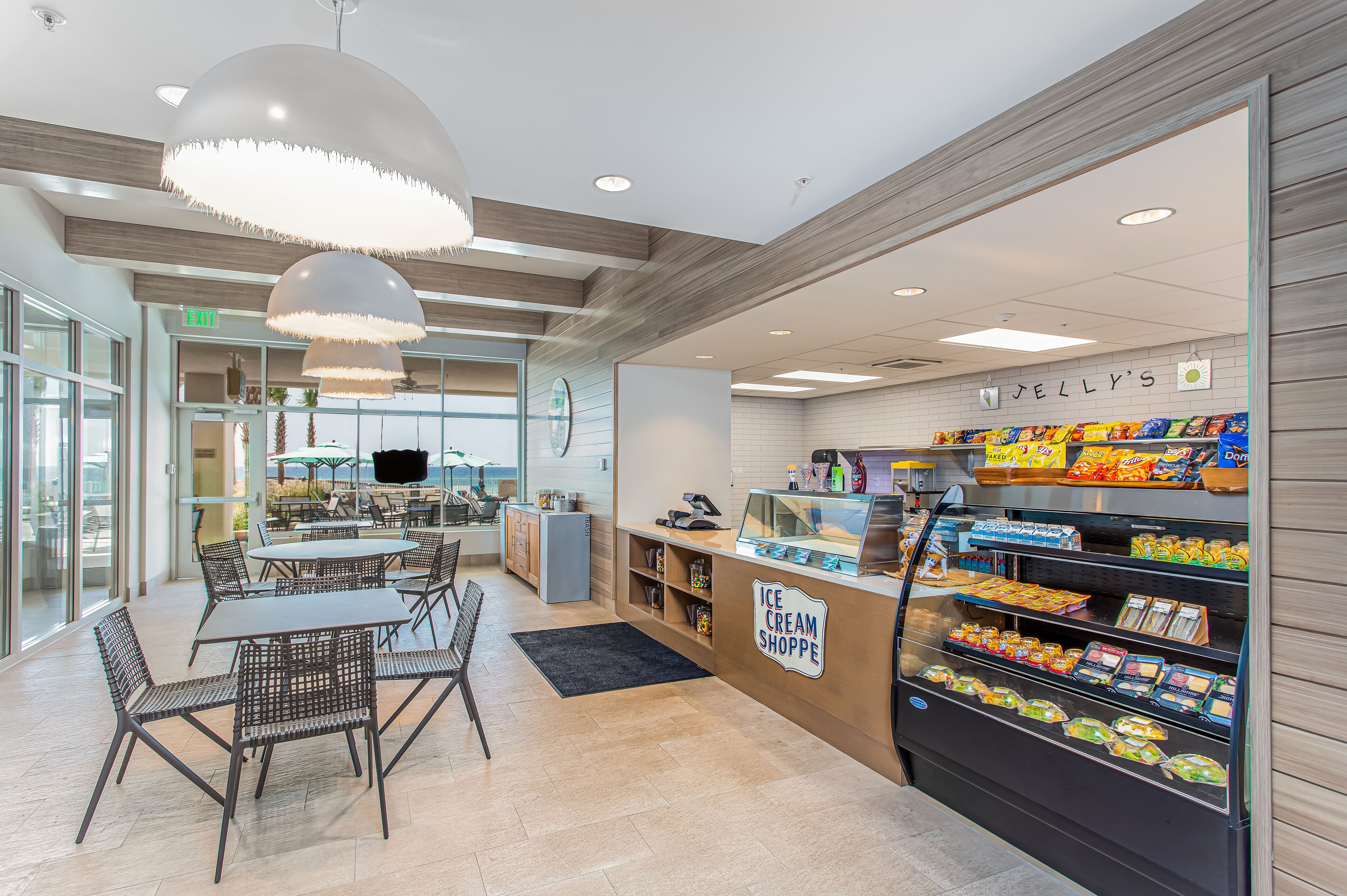 Une boutique de glaces moderne, avec un comptoir, un espace pour s’asseoir et une variété de produits glacés exposés.