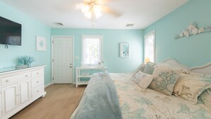 A bedroom with a bed, a dresser, a ceiling fan, and a television on the wall. - Enjoy Family Memories - Great Outdoor Decks And Backyard; A Few Houses To Beach (Surf City)