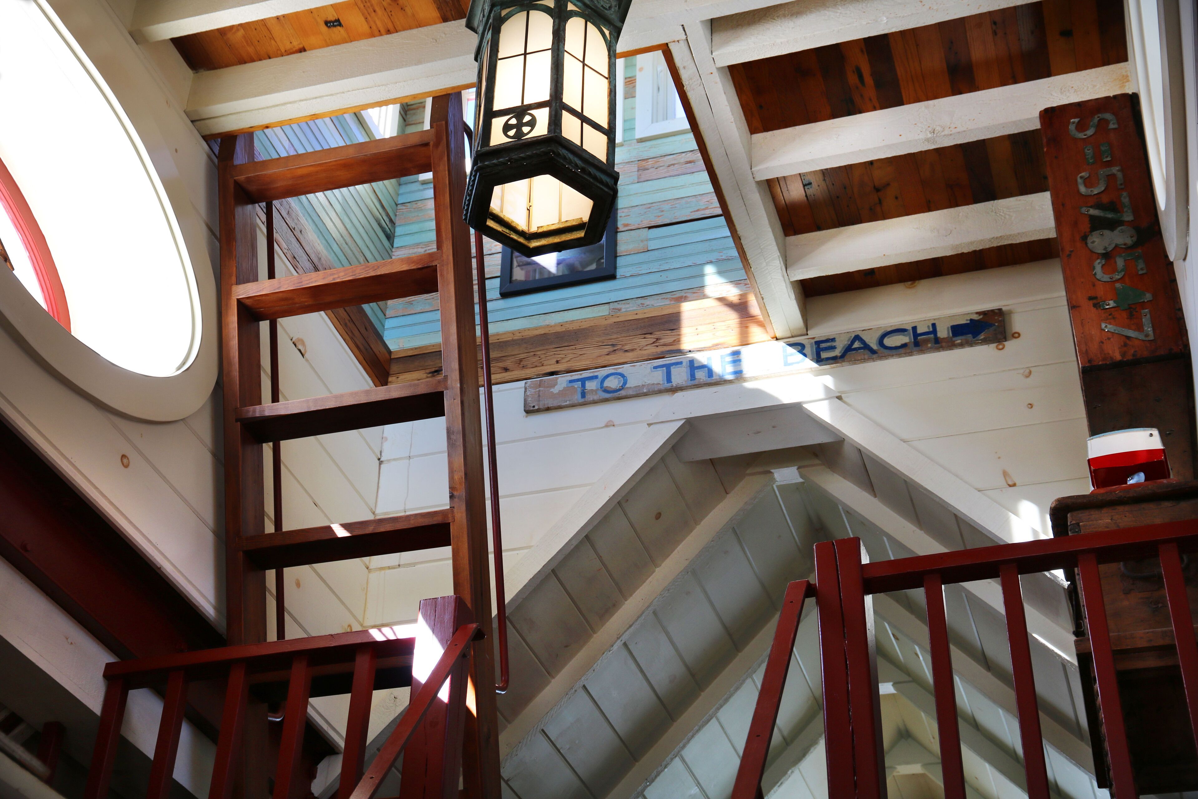 A wooden staircase with a sign reading "TO THE BEACH".