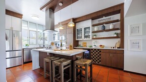A modern kitchen with a central island, stainless steel appliances, and wooden accents. - Best Spot in Puerto Rico at Rio Mar Beach  & Golf Resort 20 min. to San Juan (Río Grande)