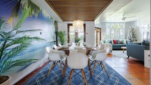 A dining area with a mural, a chandelier, and a view of the living room. - Best Spot in Puerto Rico at Rio Mar Beach  & Golf Resort 20 min. to San Juan (Río Grande)