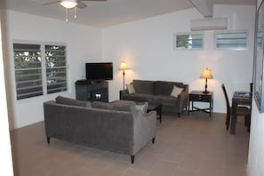 Relax in this stylish living room with a flat-screen TV, two sofas, and a coffee table.