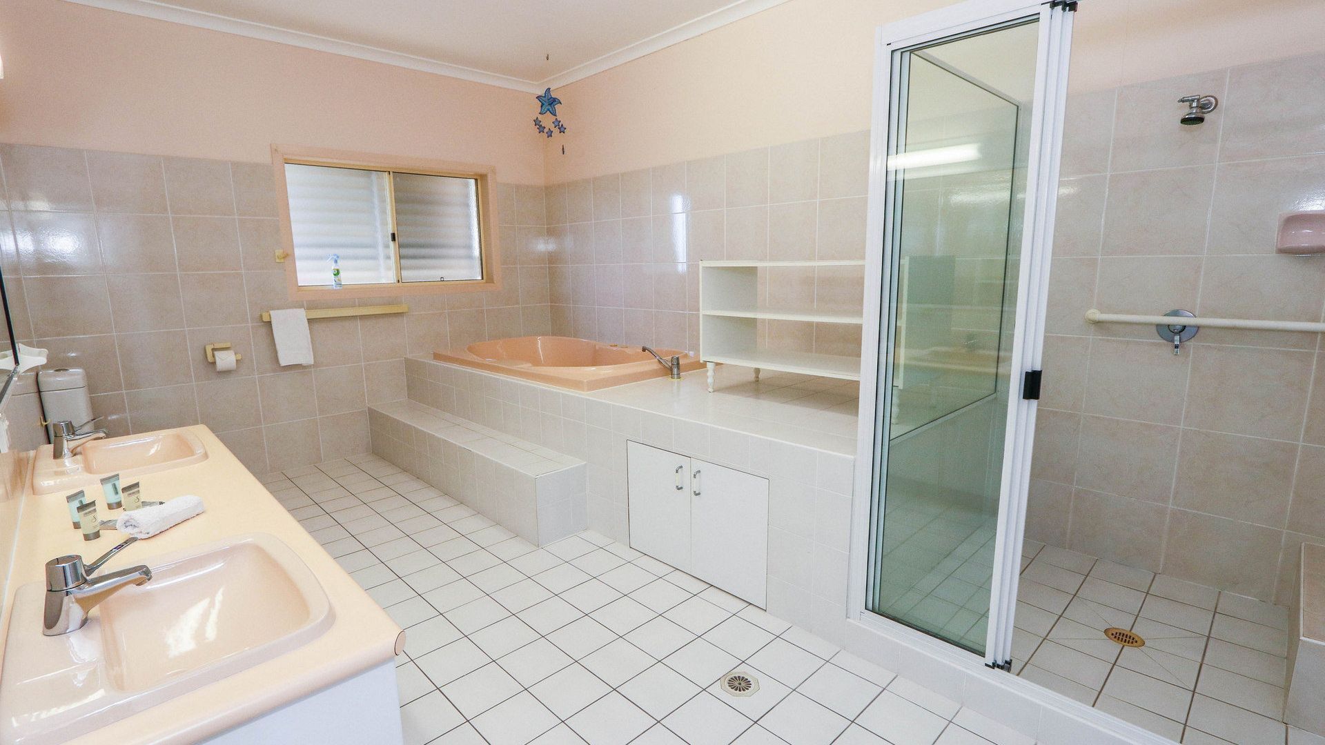 A modern bathroom with a bathtub, a shower, a sink, and a toilet.
