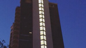 A tall building with a prominent vertical light feature. - Quiet 2/2 High-rise at the Tallahassee Center (Tallahassee)