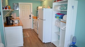 A compact kitchen with a refrigerator, microwave, and coffee maker. There is a wooden countertop and a white cabinet. - Beachfront large one bedroom studio, adjoining studio can be added to make 2/2. (Spanish Wells)