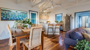 A modern interior with a dining area, kitchen, and living space.