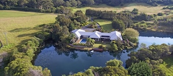 Mystique Country House-Stunning house beside a lake and mountain backdrop.