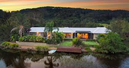 Mystique Country House-Stunning house beside a lake and mountain backdrop.