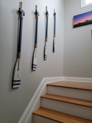 A staircase with wooden steps and a wall-mounted broom.