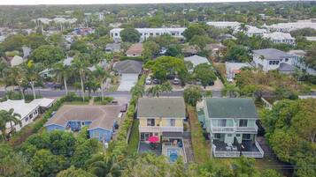A residential area with houses, a swimming pool, and a street.