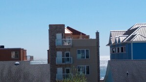Un edificio de varios pisos con balcones y vistas al océano.