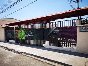 A gated entrance to Hotel Amaranto with a contact number 2101 0796 displayed on the gate. - Hotel Amaranto (San Juan)