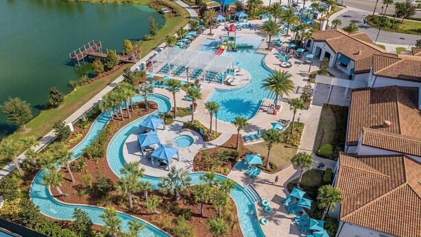 An aerial view of a resort with multiple swimming pools, palm trees, and a tennis court. - Brand new villa in amazing resort (Kissimmee)