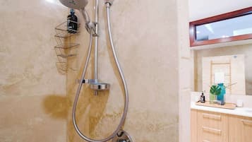 A bathroom with a shower, a towel rack, and a mirror.