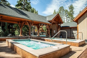 A spa area with hot tubs and a wooden deck.