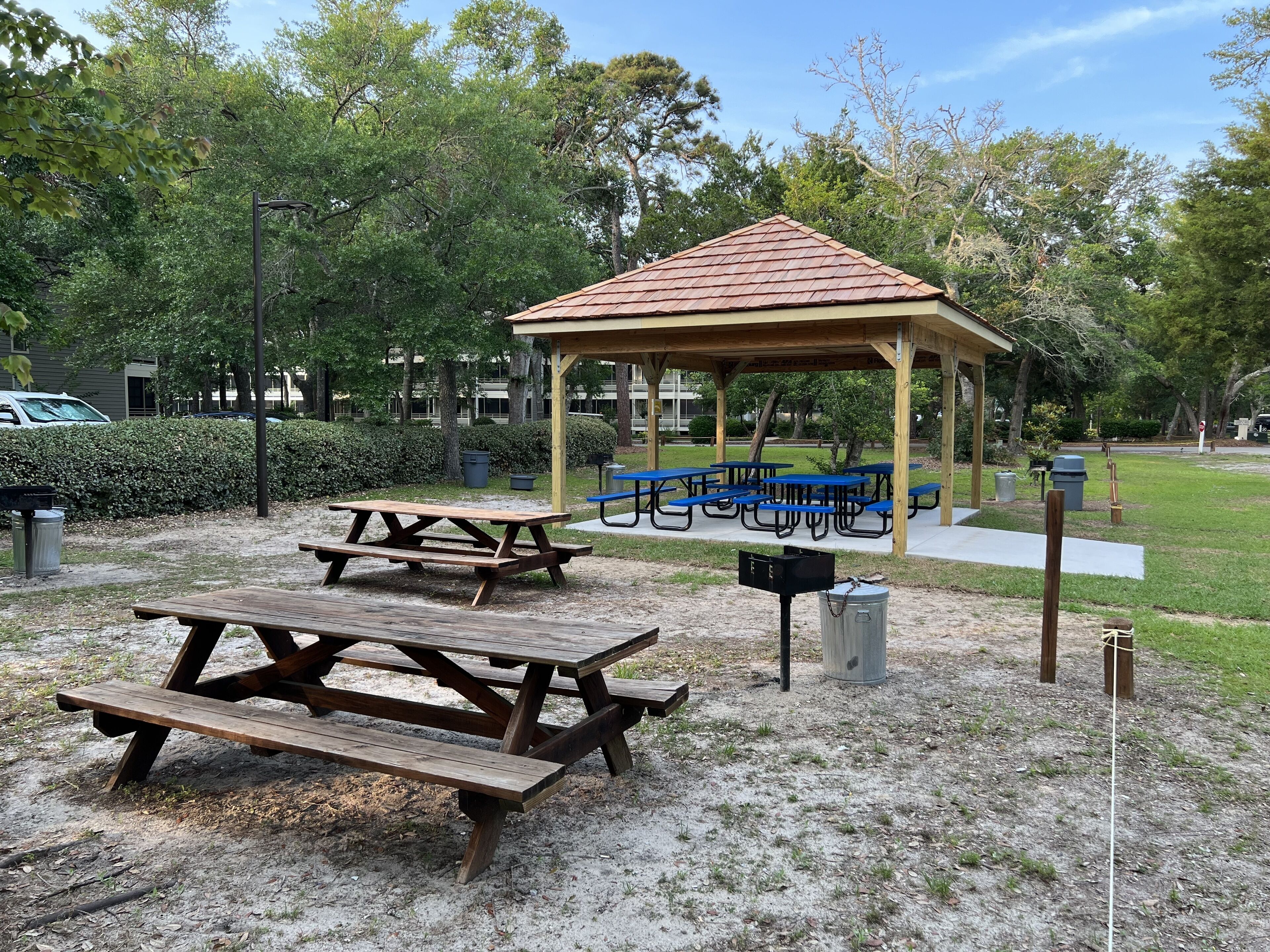 A park with picnic tables, a gazebo, and benches.