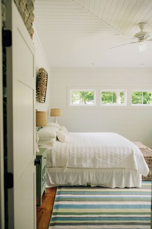 A bedroom with a bed, a nightstand, a lamp, and a window. - Lake Erie Lakefront Custom Built Cottage ~ Amazing Sunsets ~ Private!   (North East)