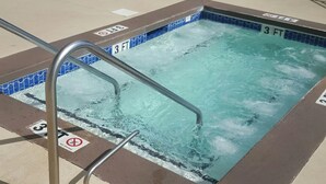 A swimming pool with a 3 FT depth marker, surrounded by lounge chairs and palm trees. - Family-Friendly Oceanfront Condo That Has A Pool, Lazy River, And Jacuzzi. (North Myrtle Beach)