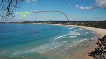 Enjoy breathtaking ocean views from a scenic beach with a picturesque bridge extending over the water.