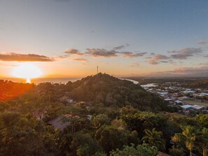 A coastal landscape with a hilltop featuring a communication tower, surrounded by dense vegetation and a small settlement. - Private piece of luxury living in Manuel Antonio - 5 minutes to Marina Pez Vela. (Manuel Antonio)