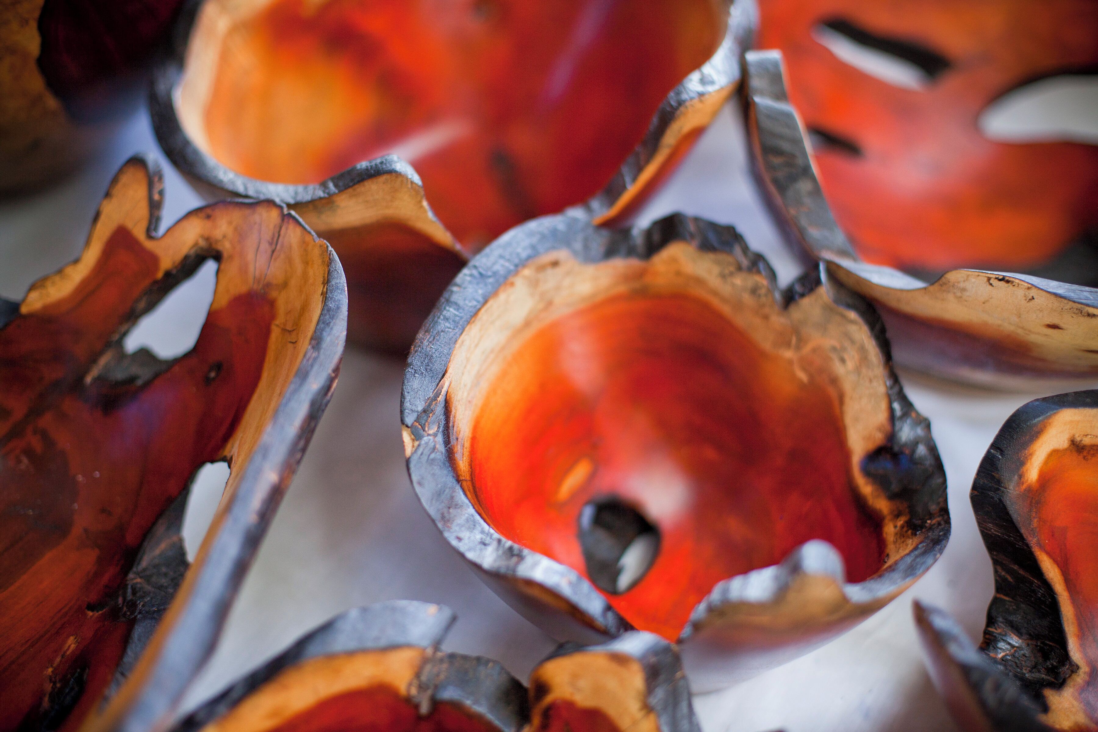 A close-up of carved wooden bowls with a glossy finish.