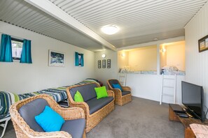 A room with a sofa set, a television, and a small table. - Ben-My-Chree (Lorne)