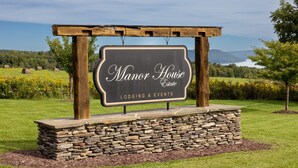 A sign for Manor House Estate advertising lodging and events. - Rent an entire lake-view estate in the heart of wine country!   (Hammondsport)