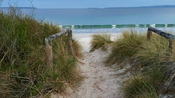 A sandy beach path leading to the ocean with a wooden fence on either side. - Pet-Friendly | 200m to Beach | Sleeps Large Groups | Beach Views | Air Con (Callala Beach)
