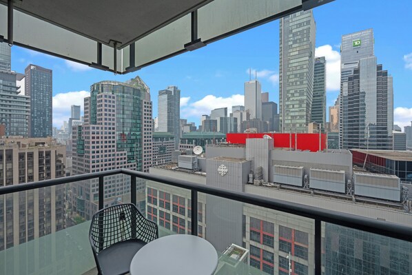 A high-rise building with a cityscape view from a balcony. - Modern Downtown Apartments (Toronto)