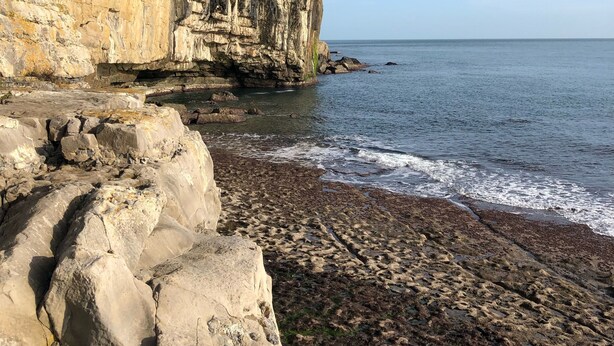 A coastal landscape with a rocky cliff and a beach. - Large Traditional Stone 3 Bedroom 1ST Floor Apartment On The Jurassic Coast. (Langton Matravers)
