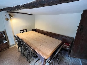 Enjoy meals in this cozy dining area with a large table and bench.