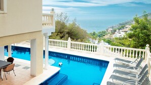 A swimming pool with a view of the sea, a white fence, and a staircase leading to a balcony. - Luxury modern villa with spectacular views of sea and heated private pool (La Herradura)