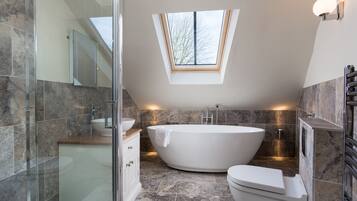 Bathtub, hair dryer, towels, toilet paper