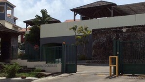A gated entrance with a sign reading "LES HAUTS CREOLES". - T3 HOUSING WITH SEA VIEW AT POINTE DU BOUT (LES TROIS ILETS)