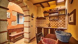 A rustic kitchen with a checkered tile backsplash, wooden shelves, and a wooden bench. - Old school from (Old School from) 1840 Wifi (Fasnia)