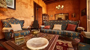 A traditional living room with patterned sofas, a wooden coffee table, and a chandelier. - Old school from (Old School from) 1840 Wifi (Fasnia)