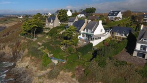 A coastal village with houses built on a cliff overlooking the sea.