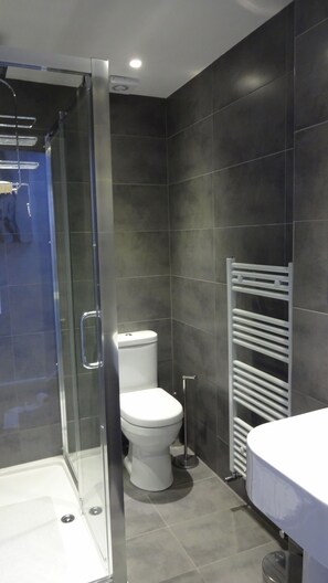 Banheira, secador de cabelo, toalhas de banho, papel higiênico