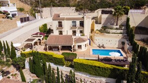 A large, multi-story villa with a swimming pool, outdoor seating, and a landscaped garden. - Moraira Sunset Villa with Private Pool, Sleeps 10, Family Friendly (MORAIRA)