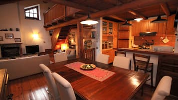A cozy dining area with a wooden table, chairs, and a red placemat.