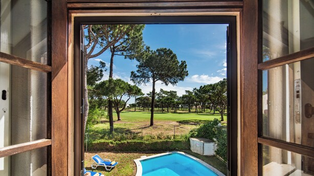 A pool with two lounge chairs, surrounded by a grassy area with trees and a clear sky. - Perfect Retreat Overlooking Pinhal Golf Course, Private pool, Off-street parking (Vilamoura)