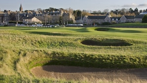 A golf course with bunkers and a clubhouse in the background. - 1 Links Crescent 5 Star Selfcatering House Overlooking Old Course in St Andrews (St Andrews)