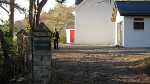 A rural setting with a white building labeled "BLYTHSWOOD" and a red structure in the background. - Fabulous House with Stunning Sea Views to Skye. By NTS gardens. Great Privacy. (Kyle of Lochalsh)