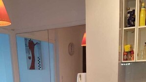 A modern kitchen with a microwave, a sink, and a cabinet with kitchen essentials. - Stunning 2 bed waterfront apartment on Nice Promenade beside the Radisson Hotel (Nice)