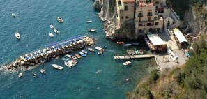 A coastal town with a marina, buildings, and boats. - B&B NARCISO with private parking (Conca dei Marini, Campania)