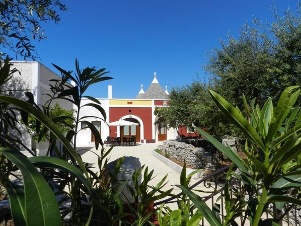 Stunning hotel with a unique architectural style, surrounded by lush gardens and a tranquil water feature.