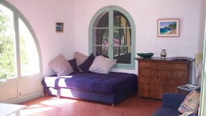 A room with a bed, a desk, a dresser, and a window with a view of greenery. - House / Villa - Rayol-Canadel-sur-Mer (Rayol-Canadel-Sur-Mer)
